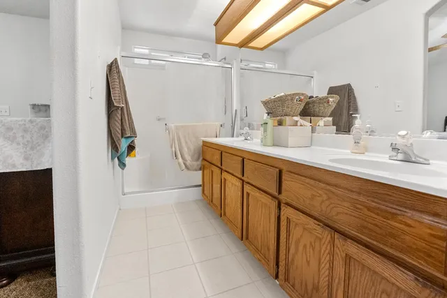 a bathroom with a double vanity sink and mirror