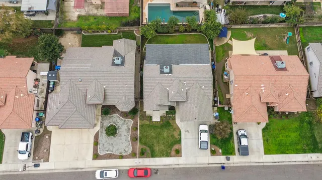 an aerial view of a house with outdoor space and lake view