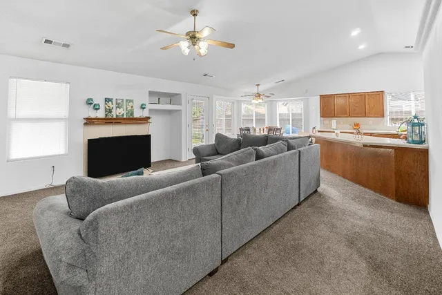 a living room with furniture a fireplace and a flat screen tv