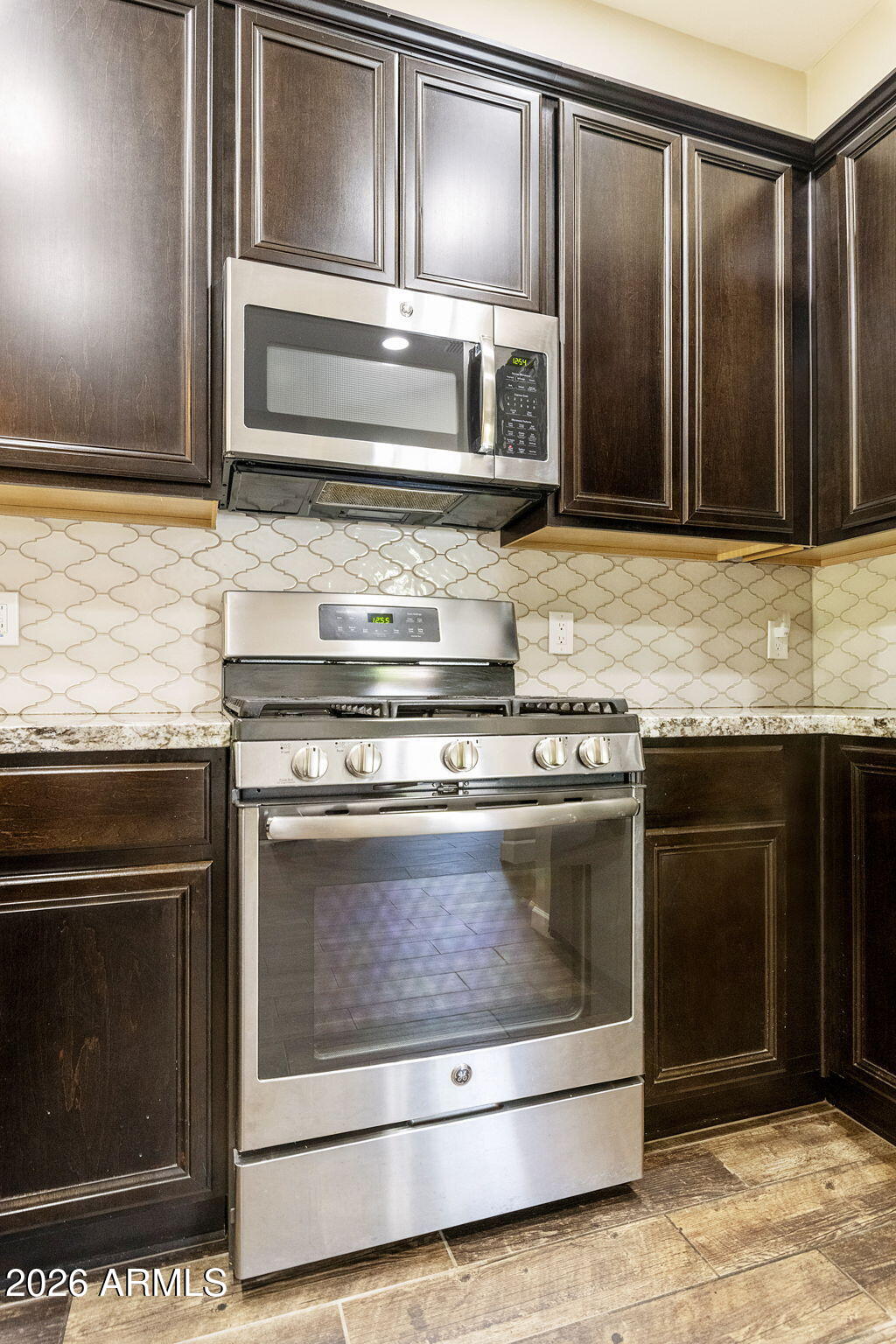 4777 South Fulton Ranch Boulevard, Unit 1123 Chandler, AZ 85248 - Photo 3 of 18 a stove top oven sitting inside of a kitchen