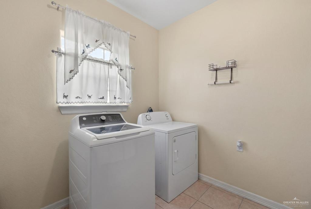 605 South Whalen Road Donna, TX 78537 - Photo 21 of 21 Bathroom featuring a single vanity with wood-finish cabinetry and a built-in sink, a large wall-mounted mirror, and a tiled shower enclosure with a frosted window