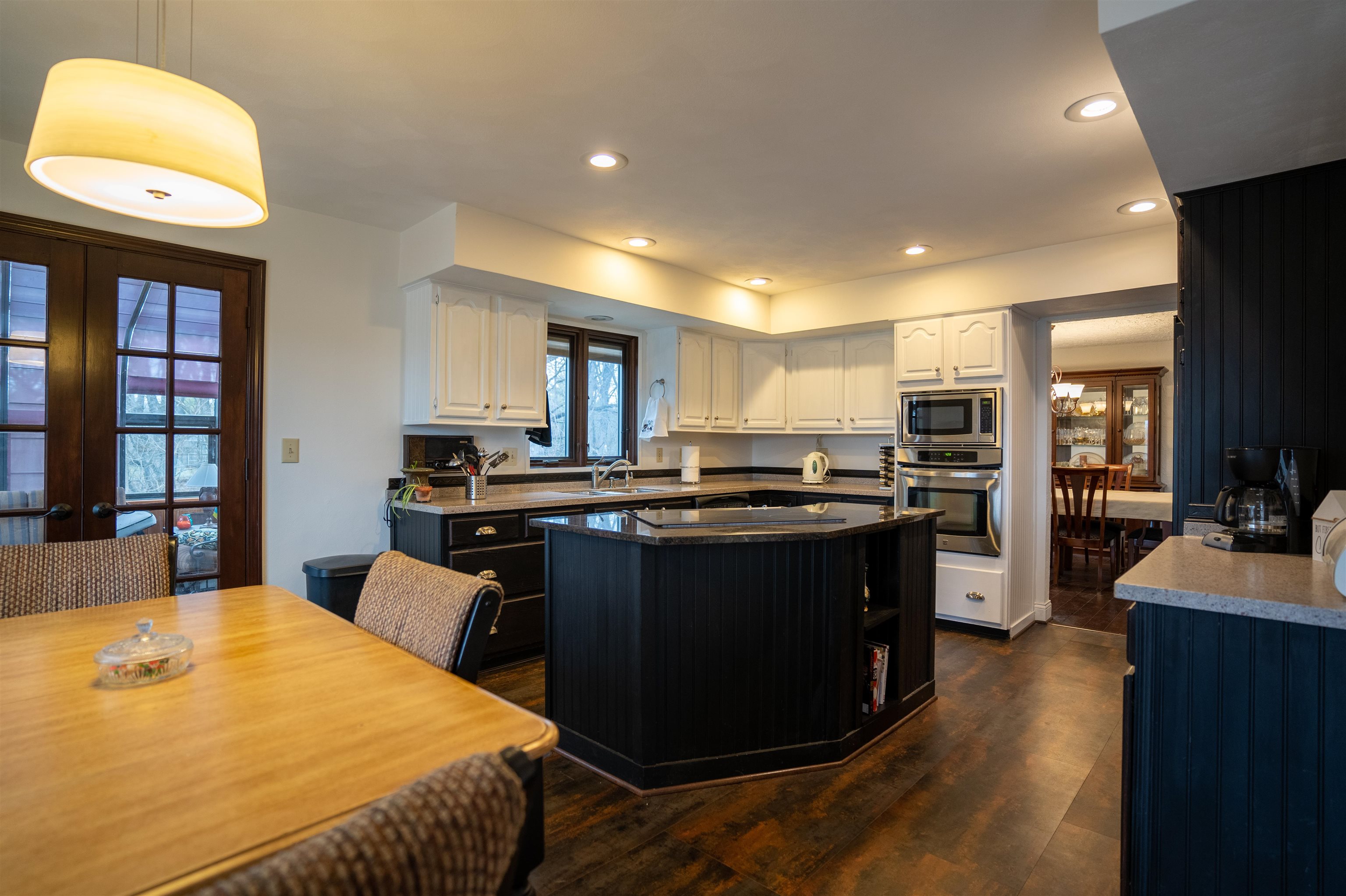 11662 Bend River Road Roscoe, IL 61073 - Photo 13 of 61 a kitchen with a chandelier appliances and a dining table