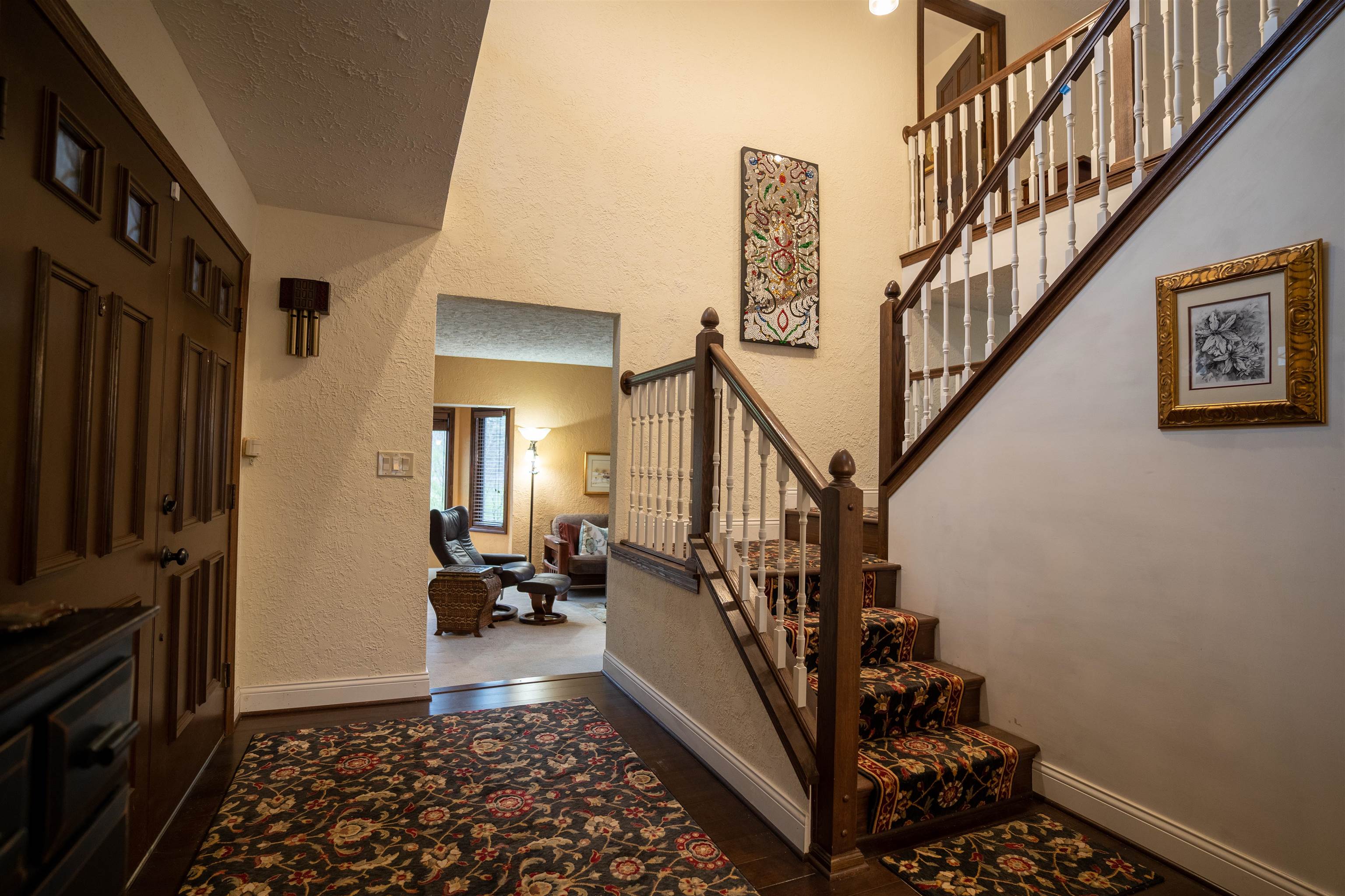 11662 Bend River Road Roscoe, IL 61073 - Photo 20 of 61 a view of staircase with lots of frames on wall and a window