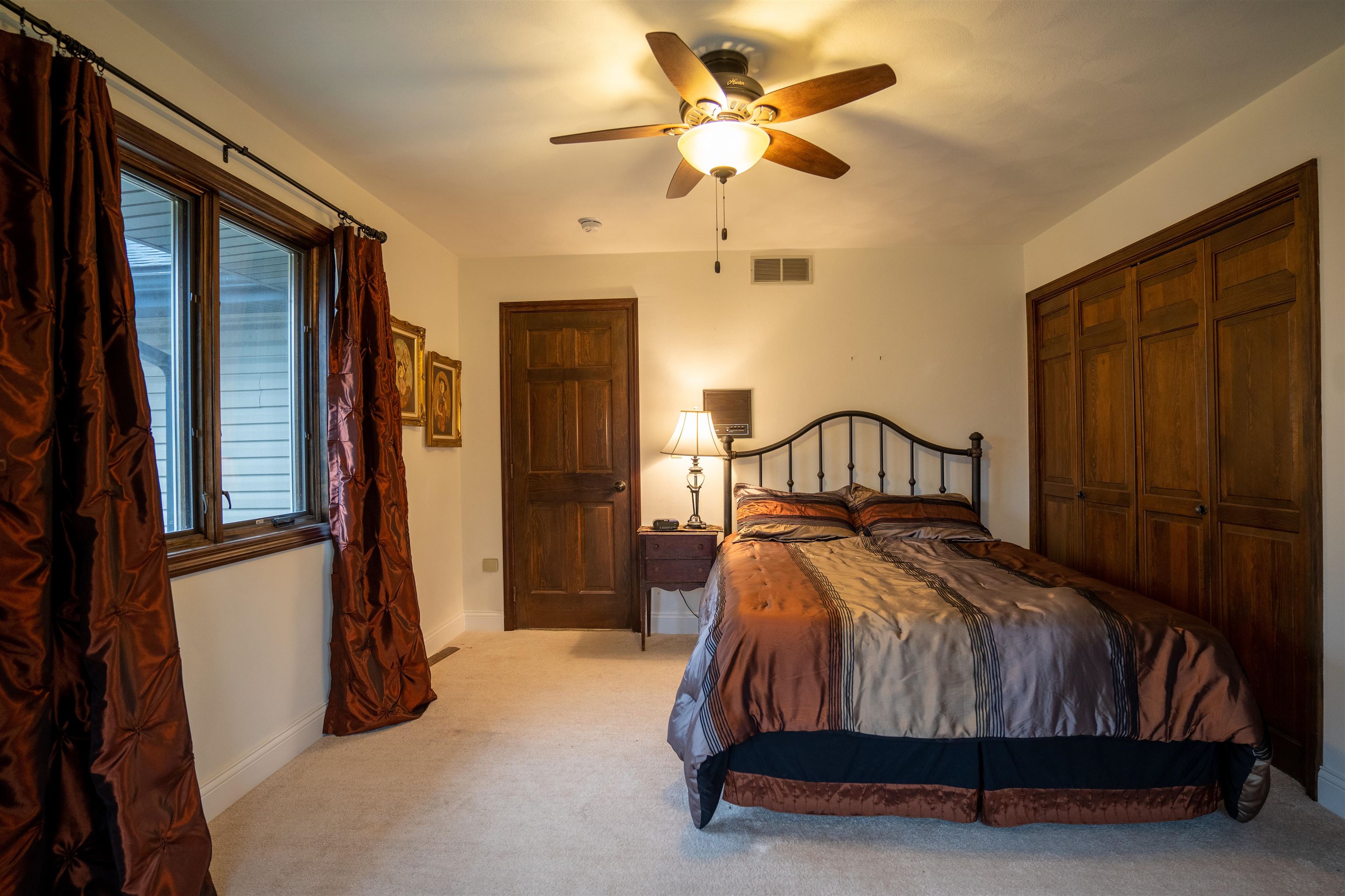 11662 Bend River Road Roscoe, IL 61073 - Photo 25 of 61 a bedroom with a bed lamp and a chandelier