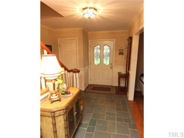 7819 Harps Mill Road Raleigh, NC 27615 - Photo 2 of 21 Family and guests will be greeted in a foyer featuring beautiful slate flooring and rich wood stairs and handrails Foyer