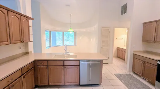 a kitchen with a sink cabinets and window