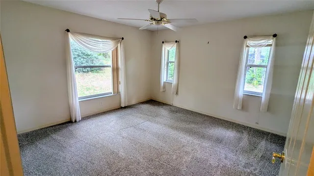 an empty room with windows and entrance