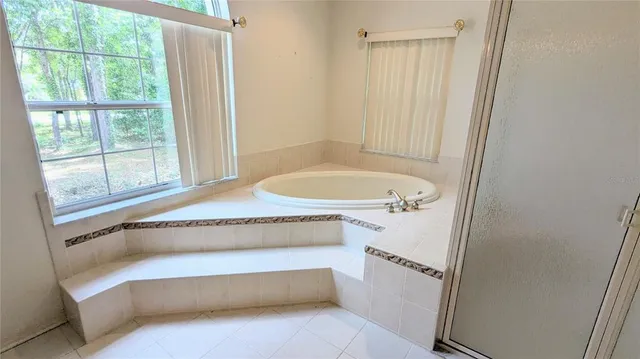 a bathroom with a tub and a window