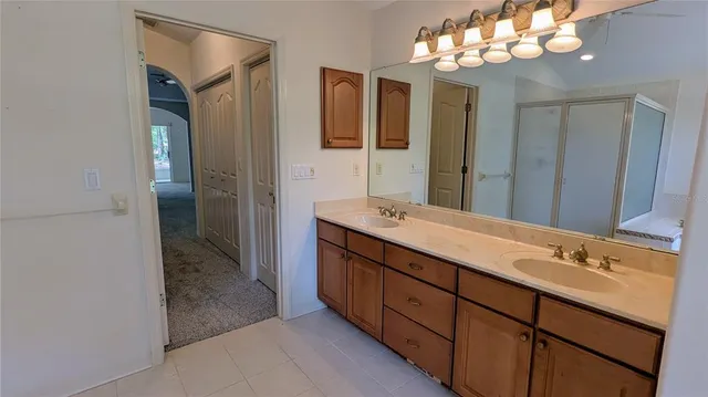 a bathroom with a double vanity sink and a mirror