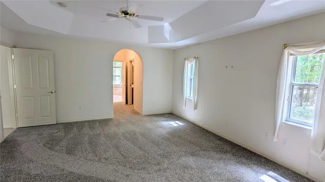 an empty room with windows and closet