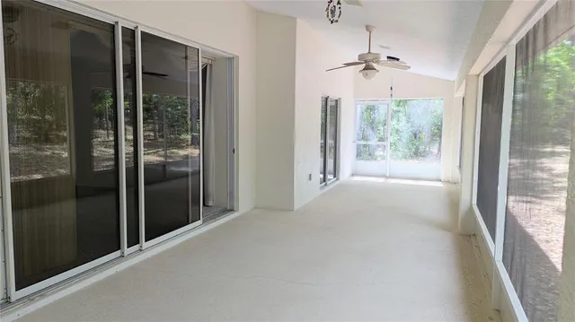 a view of hallway with windows