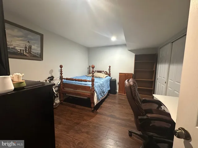 a spacious bedroom with two beds and a desk