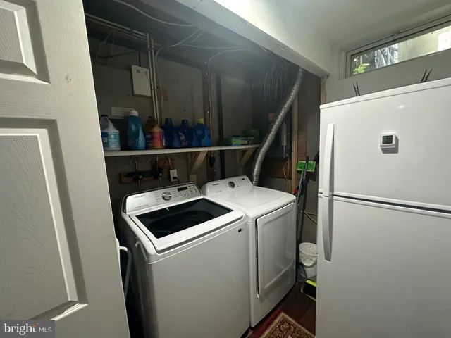 a view of storage and utility room with washer and dryer
