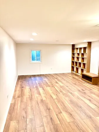 a view of a room with wooden floor