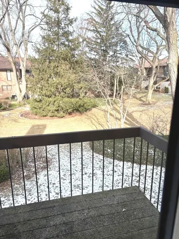 a view of a yard with wooden fence