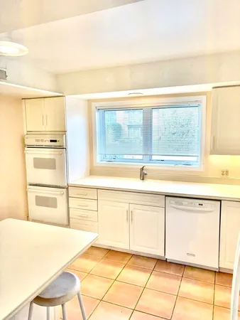 a large bathroom with a bathtub and a sink