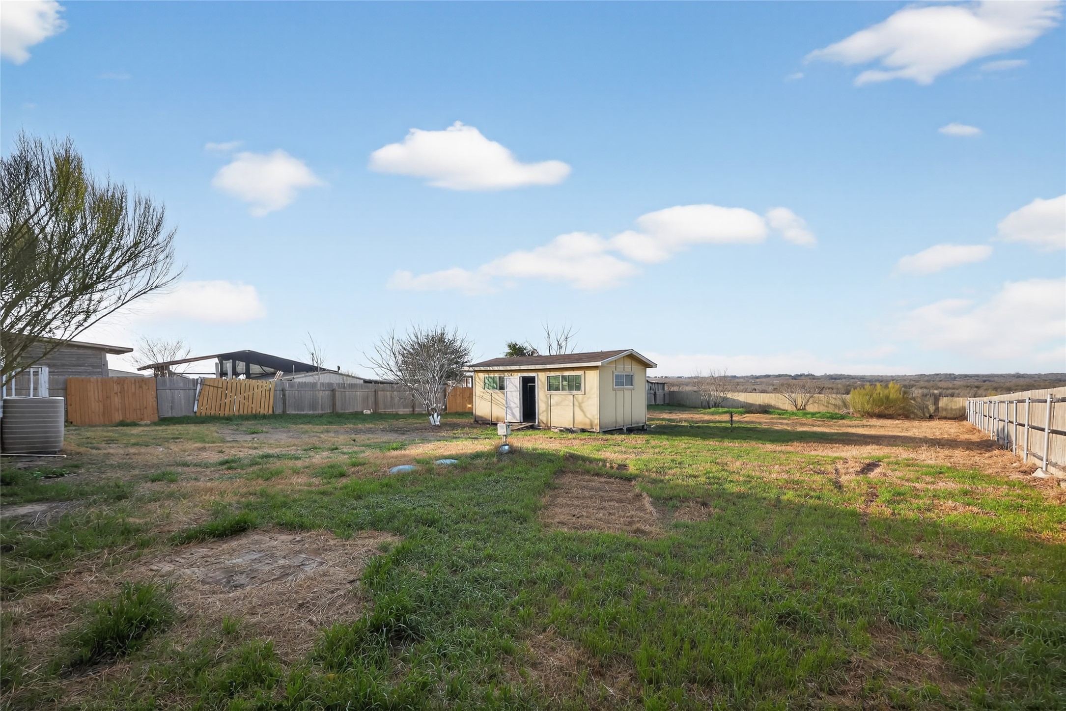 2674 Cotton Gin Road Kyle, TX 78640 - Photo 5 of 30 Fenced backyard with an outbuilding