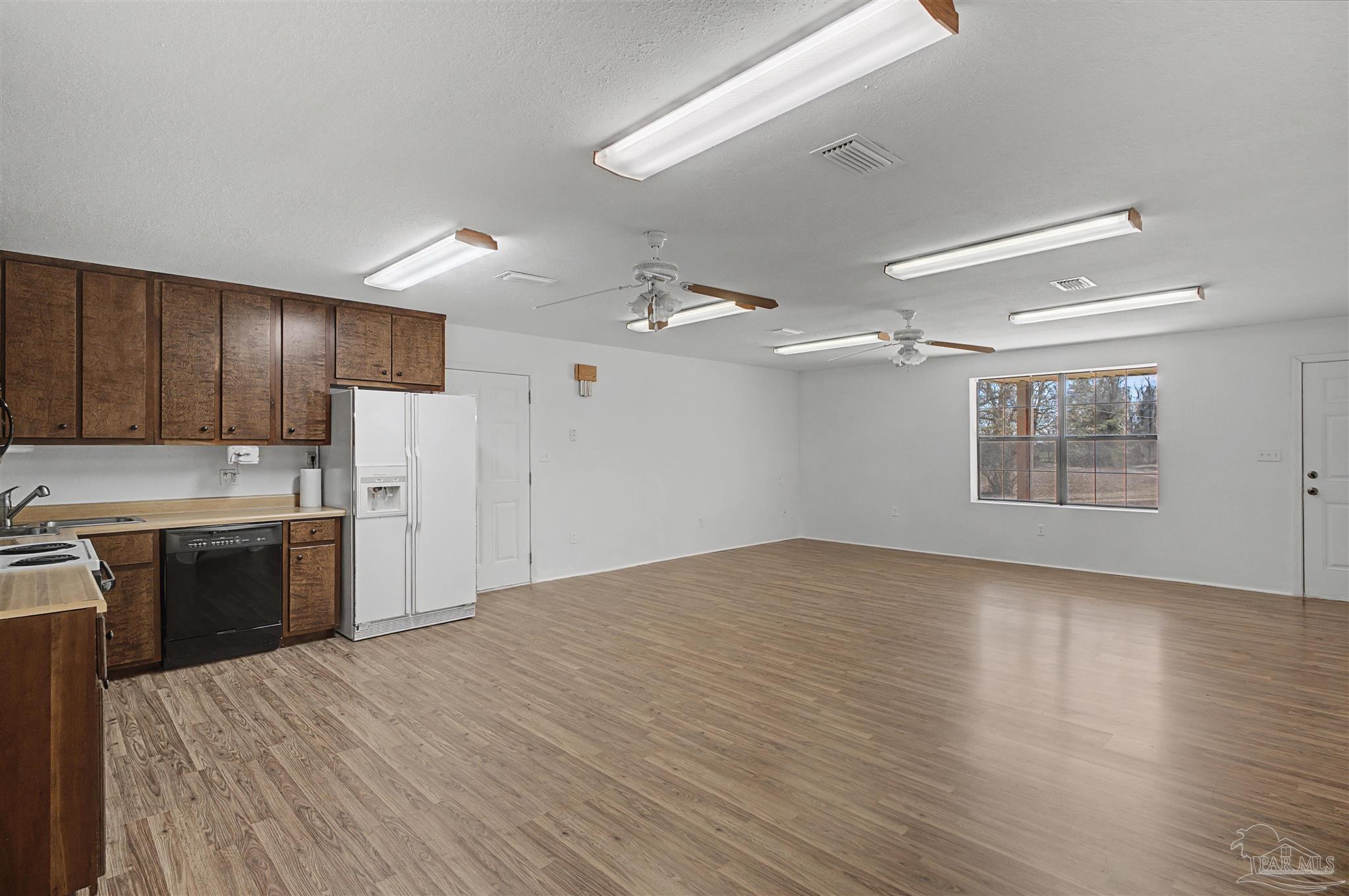3401 Rocky Road Jay, FL 32565 - Photo 11 of 45 a kitchen with stainless steel appliances kitchen island granite countertop a refrigerator oven a sink dishwasher and a stove with wooden floor
