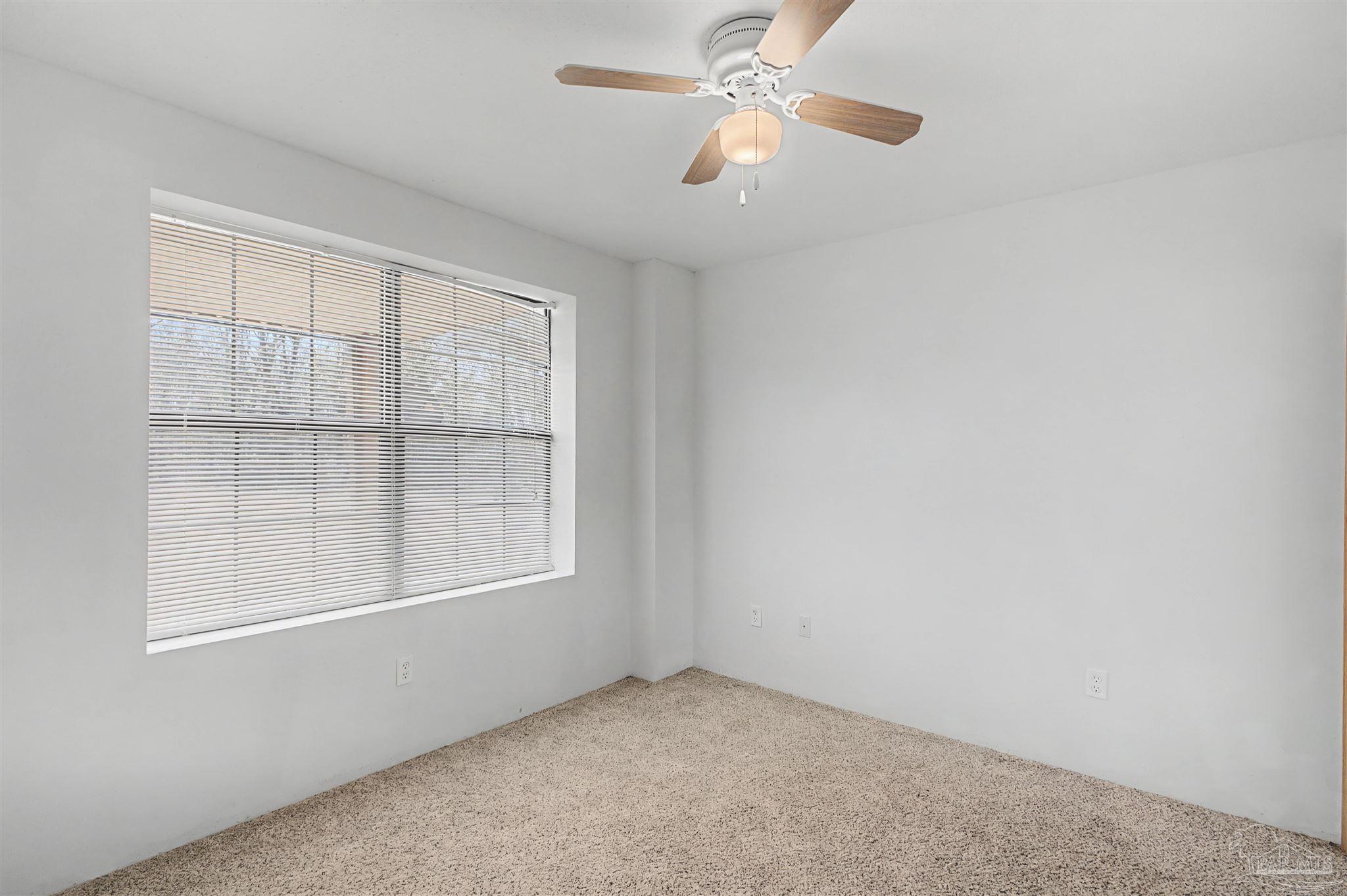 3401 Rocky Road Jay, FL 32565 - Photo 21 of 45 an empty room with windows and fan