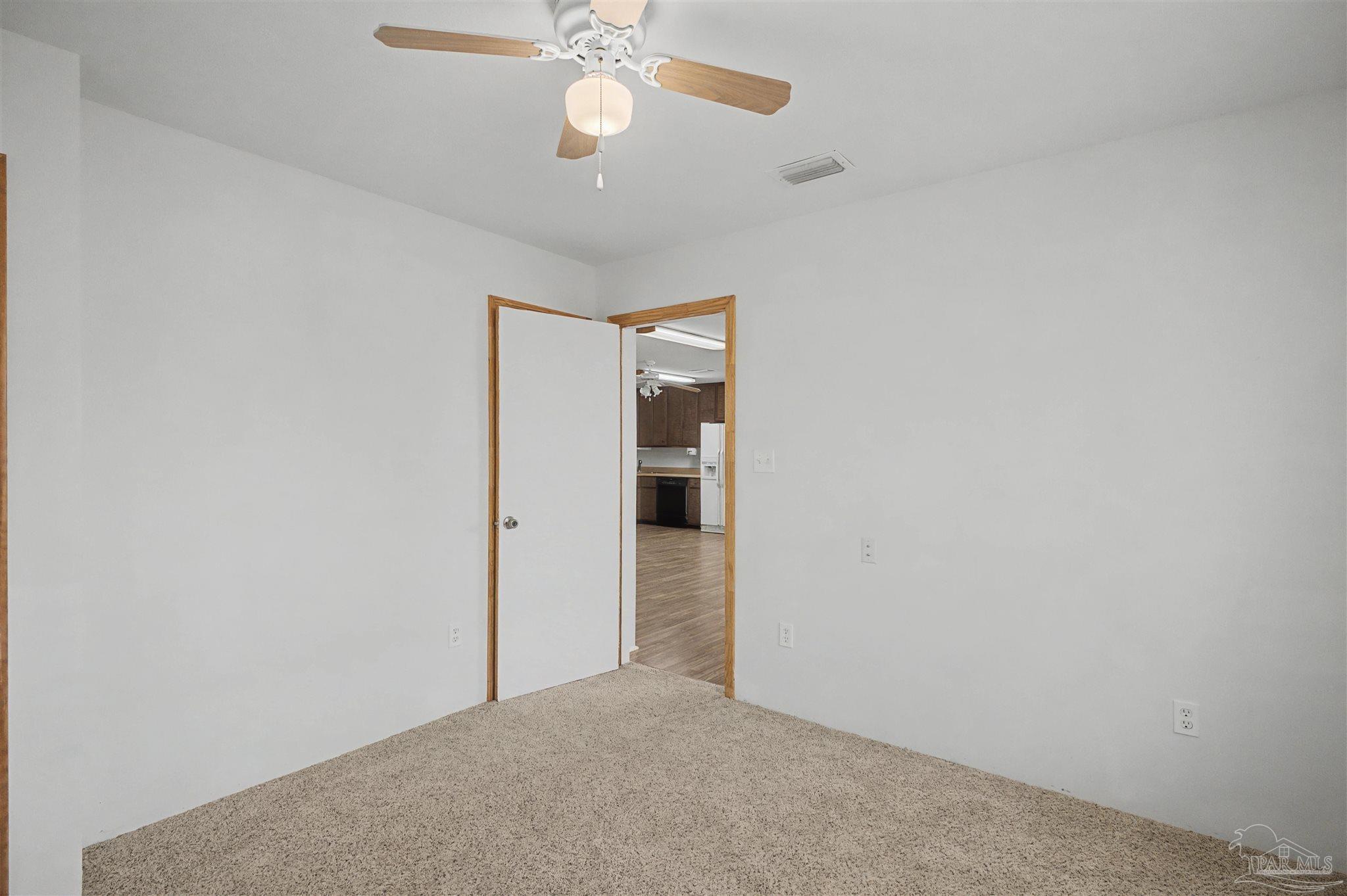 3401 Rocky Road Jay, FL 32565 - Photo 22 of 45 en empty room with a ceiling fan and a window