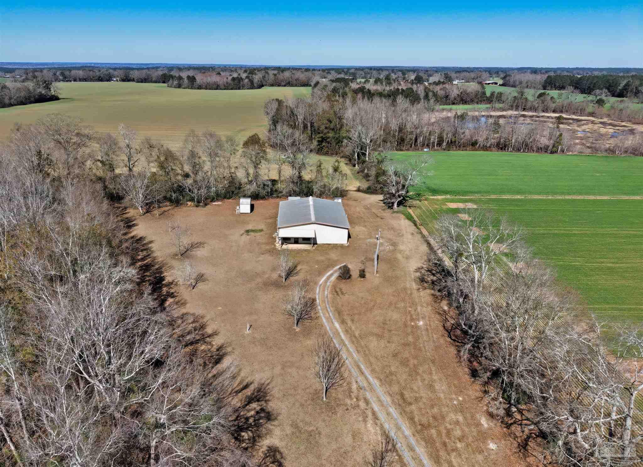 3401 Rocky Road Jay, FL 32565 - Photo 32 of 45 a view of a lake with a building in the background