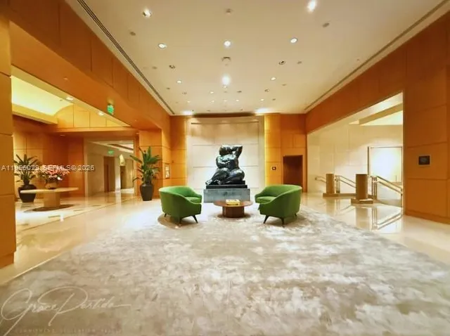 a room with lots of potted plants and a view of living room