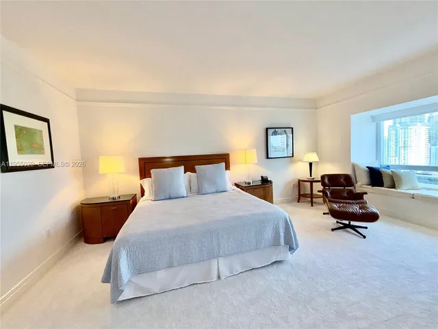 a bedroom with bed chair and window