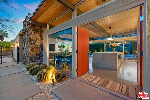 a view of outdoor living space with patio furniture and potted plants