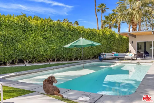 a view of a swimming pool with a patio