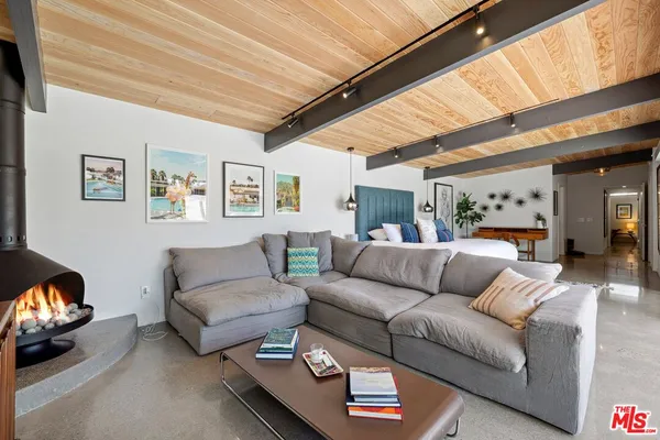 a living room with furniture and a floor to ceiling window