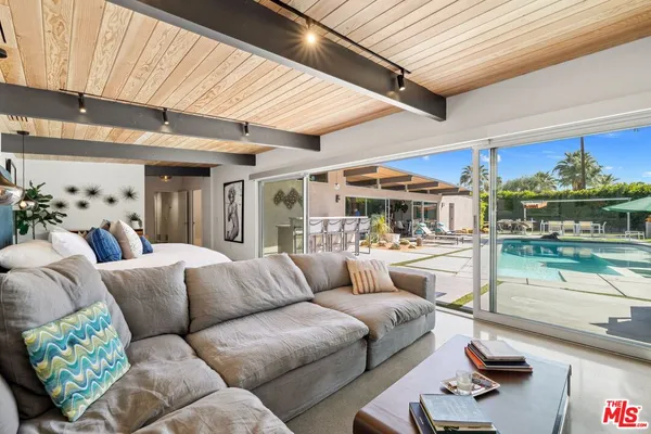 a bedroom with a bed and table chair