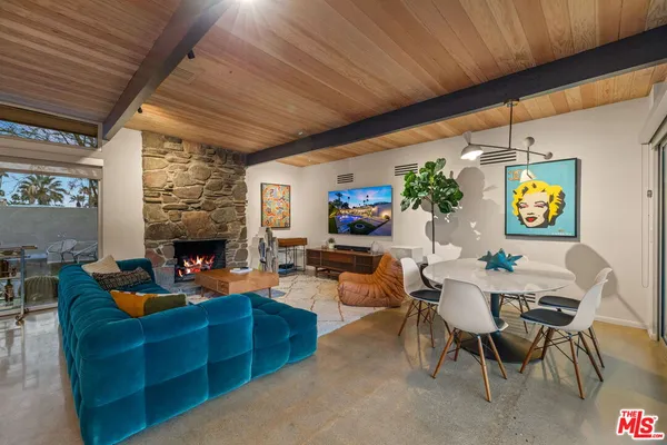 a living room with furniture a fireplace and a black umbrella