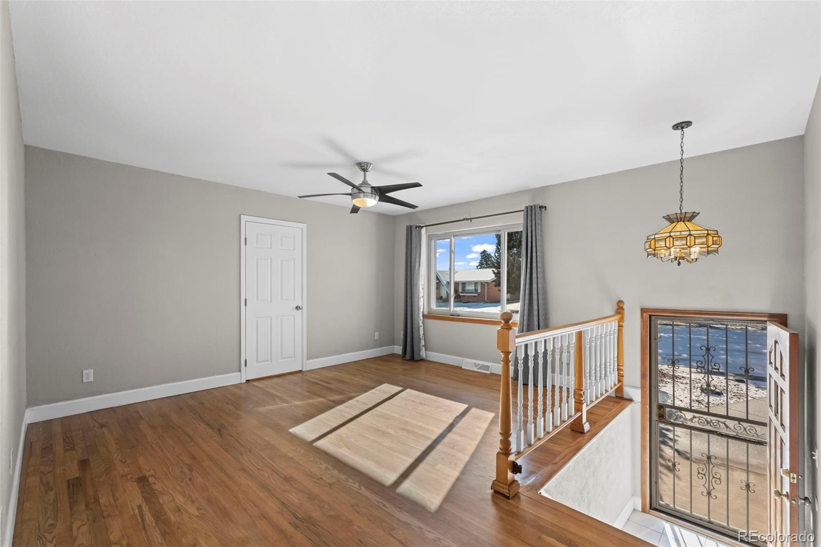 8213 Adams Way Denver, CO 80221 - Photo 3 of 22 a view of livingroom with hardwood floor and a ceiling fan