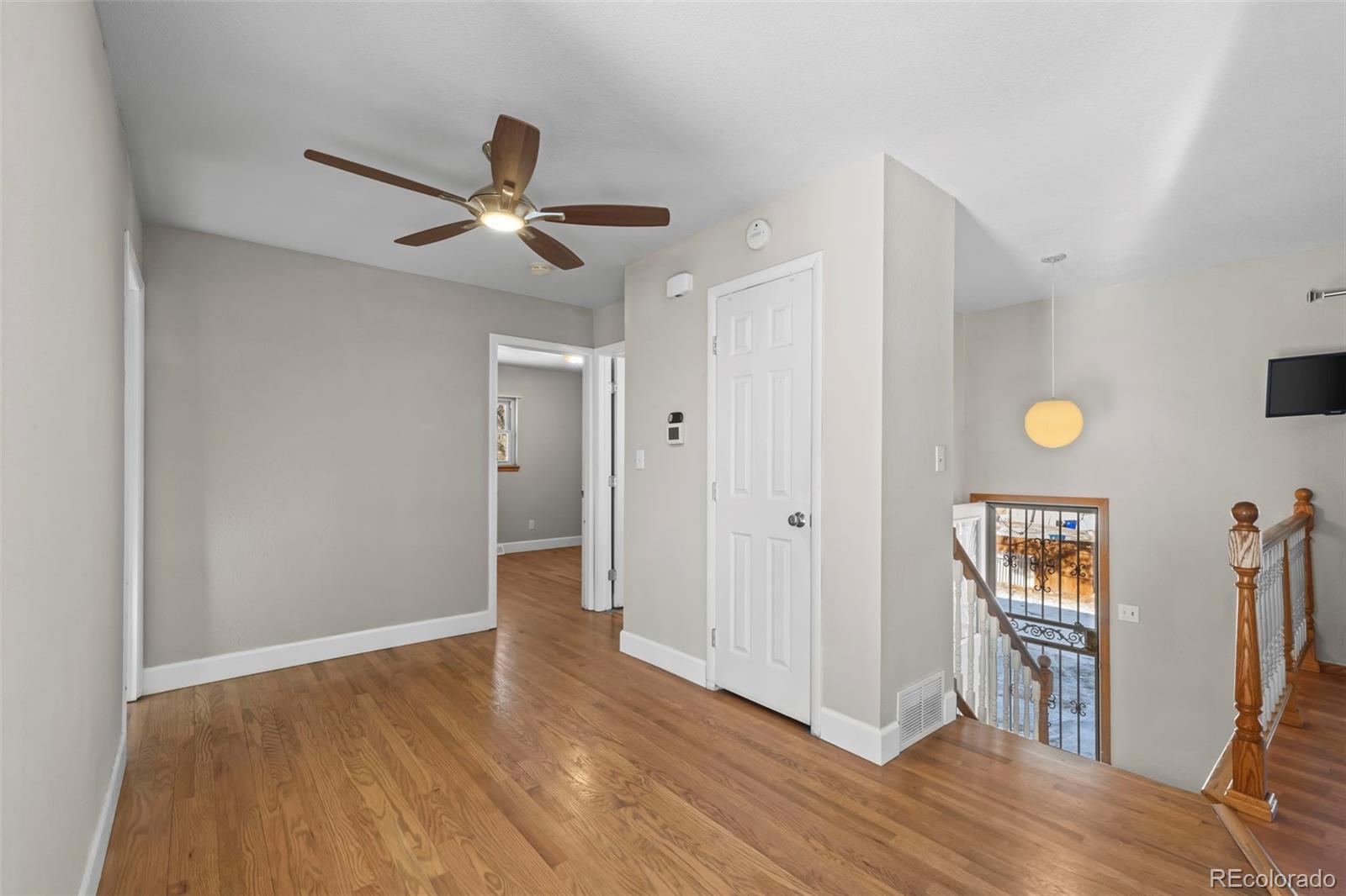 8213 Adams Way Denver, CO 80221 - Photo 8 of 22 a view of entryway with wooden floor