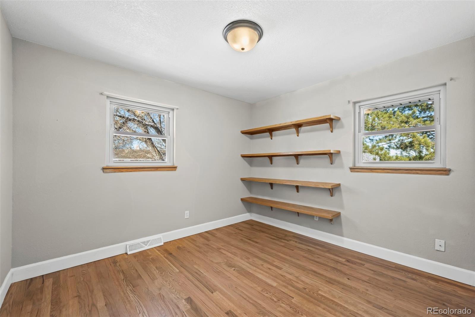 8213 Adams Way Denver, CO 80221 - Photo 9 of 22 a view of a room with wooden floor and window