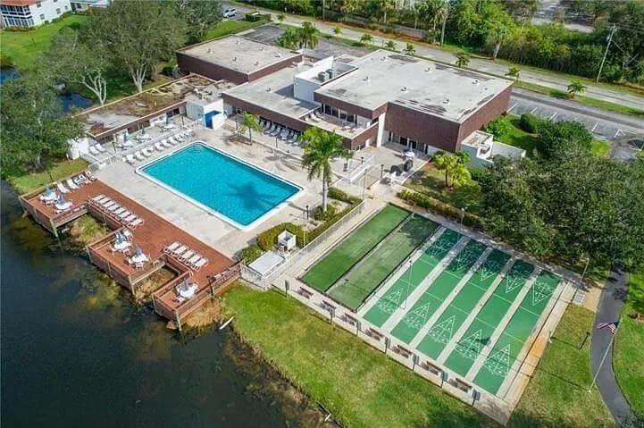 1225 Northwest 21st Street, Unit 3507 Stuart, FL 34994 - Photo 16 of 18 an aerial view of a house with a yard swimming pool and outdoor seating