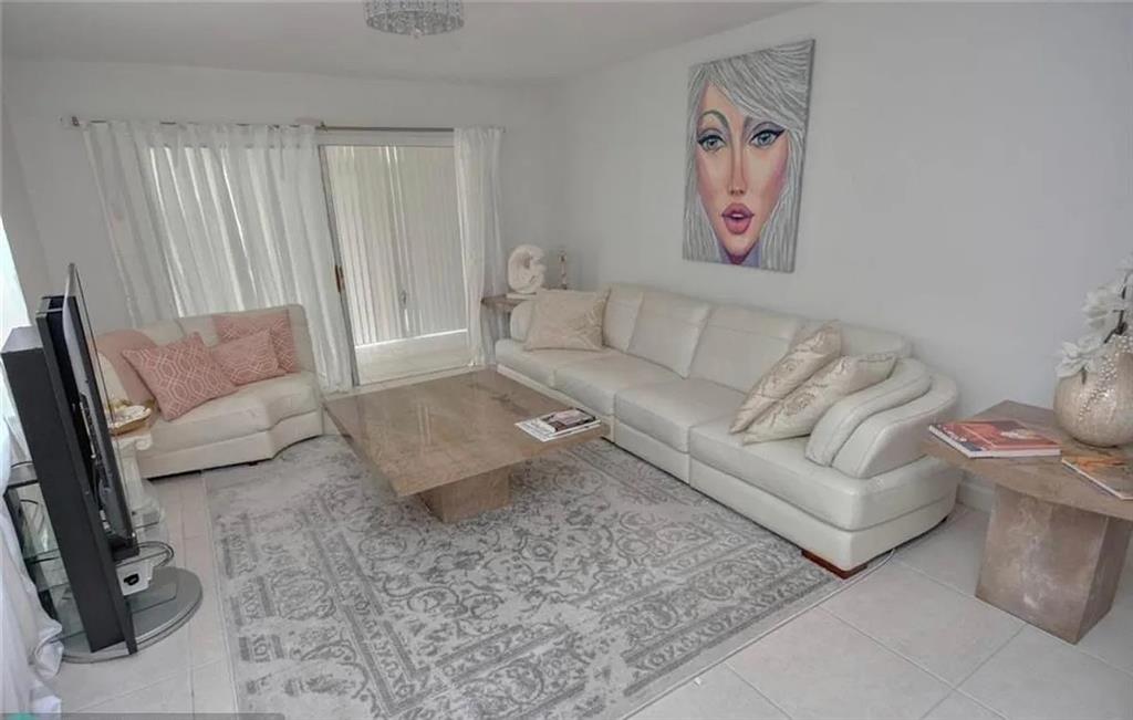 1225 Northwest 21st Street, Unit 3507 Stuart, FL 34994 - Photo 5 of 18 a living room with furniture and a couch