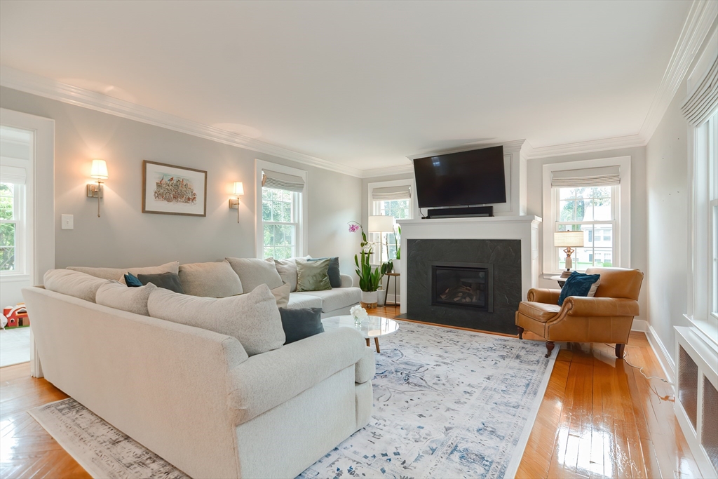 1133 Brook Road Milton, MA 02186 - Photo 13 of 40 a living room with furniture a flat screen tv and a fireplace