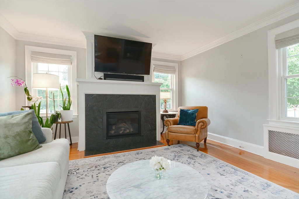 1133 Brook Road Milton, MA 02186 - Photo 14 of 40 a living room with furniture a flat screen tv and a fireplace