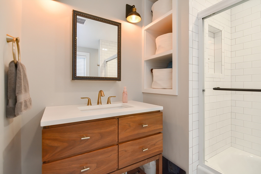 1133 Brook Road Milton, MA 02186 - Photo 18 of 40 a bathroom with a sink vanity and a mirror