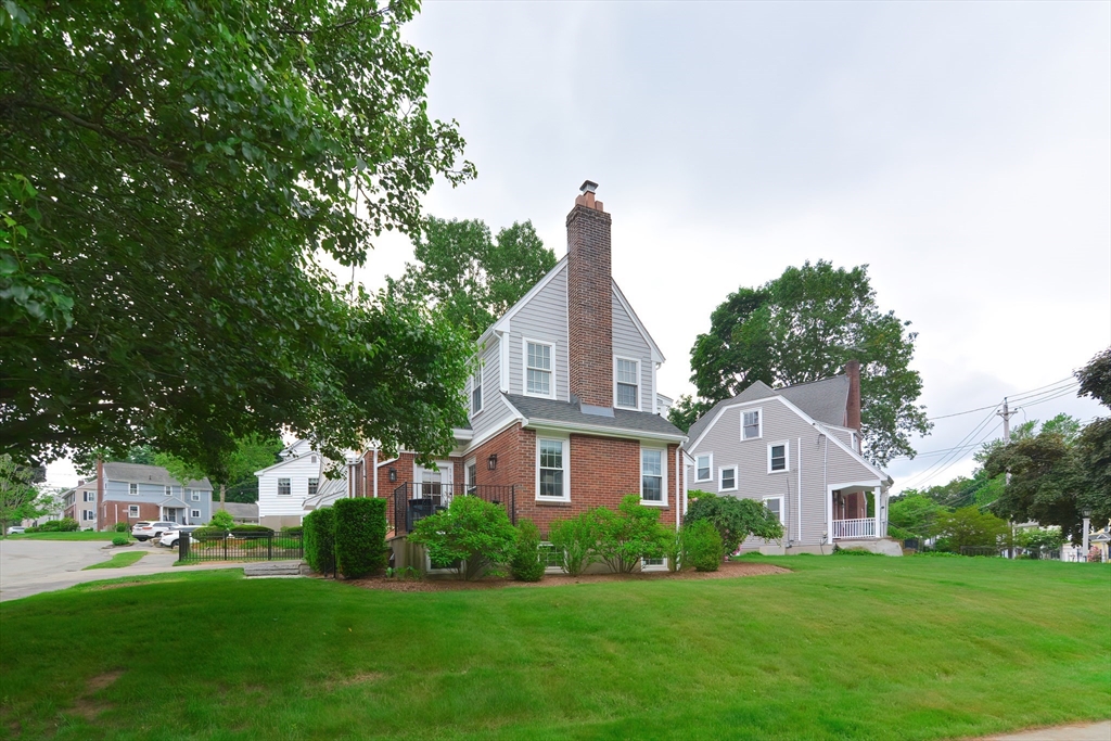 1133 Brook Road Milton, MA 02186 - Photo 2 of 40 a front view of a house with a yard