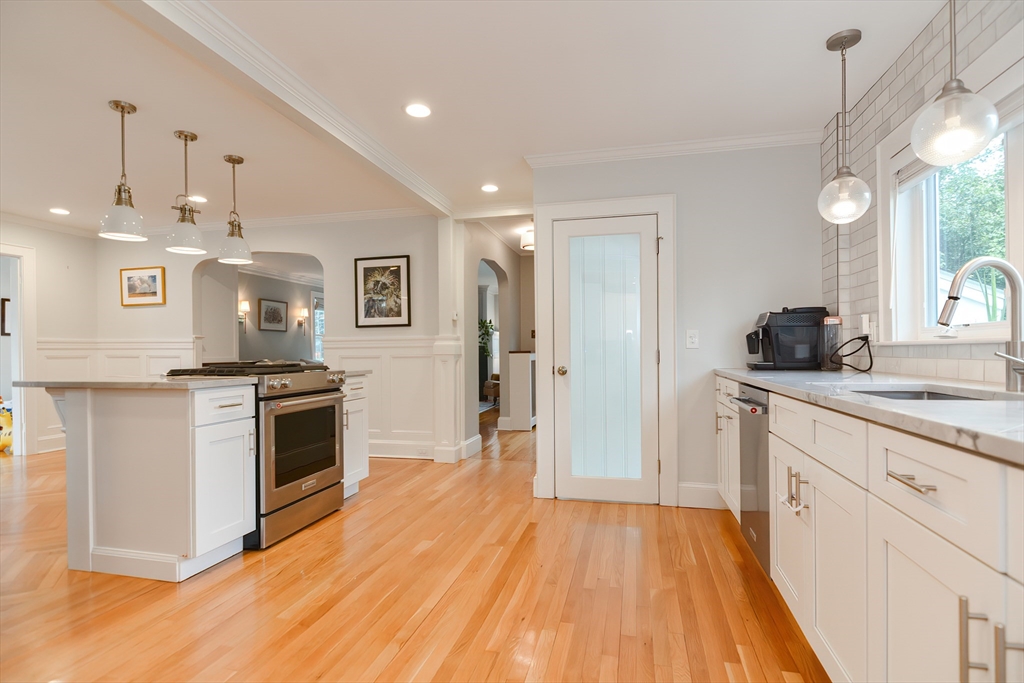 1133 Brook Road Milton, MA 02186 - Photo 24 of 40 a kitchen with granite countertop a stove top oven a sink dishwasher and a refrigerator with wooden floor