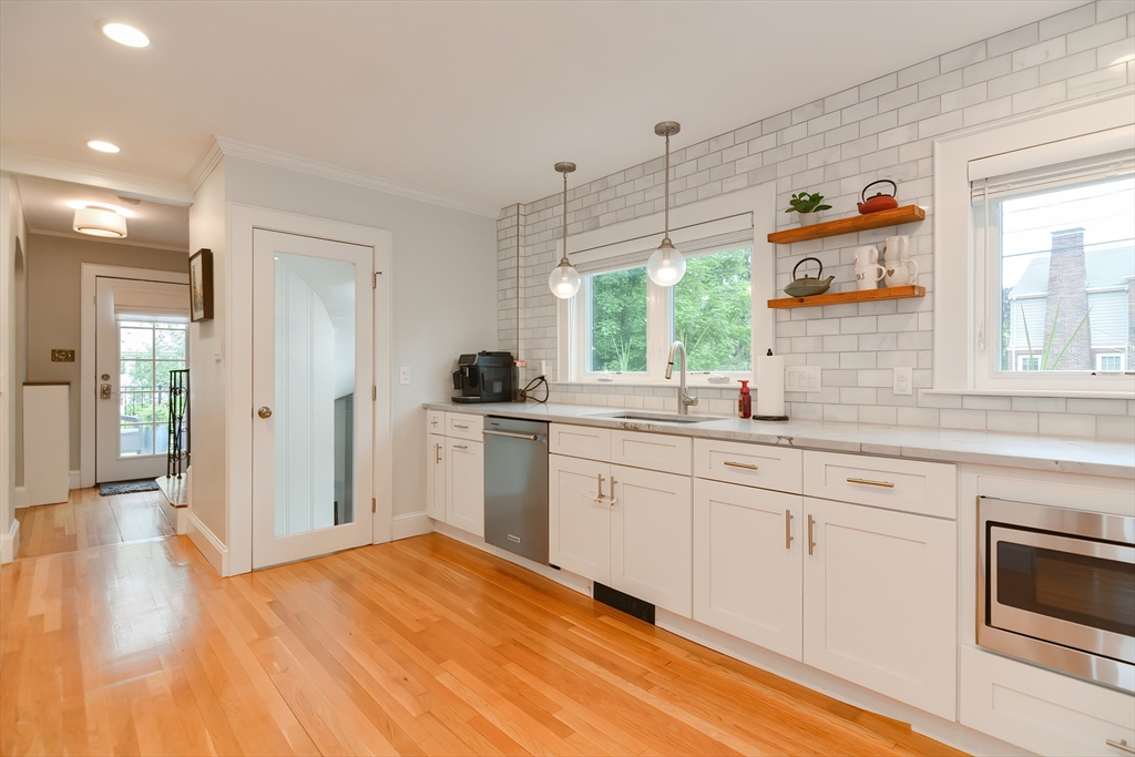 1133 Brook Road Milton, MA 02186 - Photo 25 of 40 a kitchen with granite countertop a stove a sink and a refrigerator
