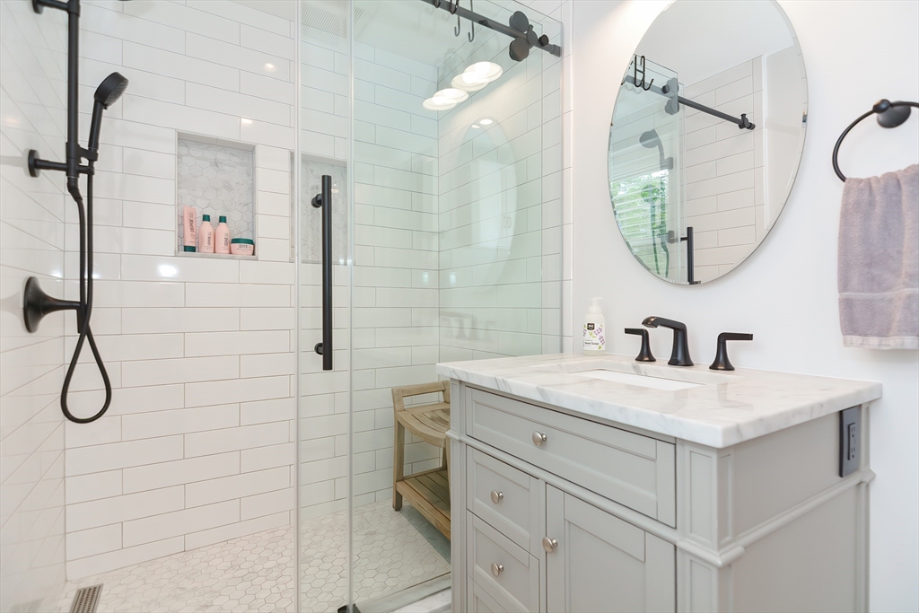 1133 Brook Road Milton, MA 02186 - Photo 33 of 40 a bathroom with a sink vanity and a mirror