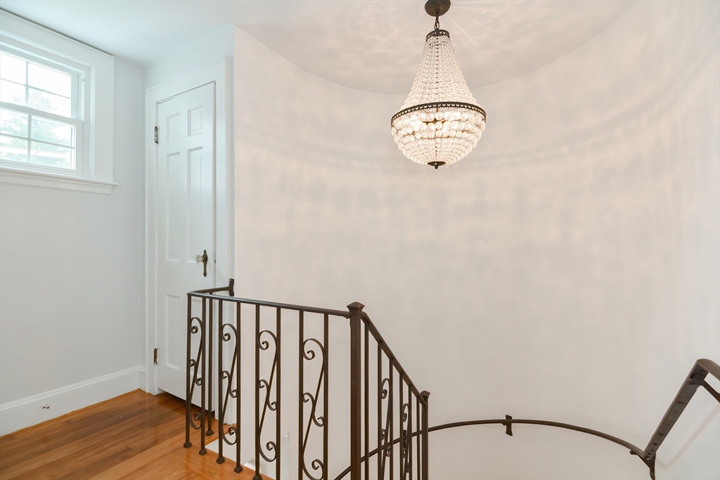 1133 Brook Road Milton, MA 02186 - Photo 37 of 40 a view of a hallway with wooden floor and a window