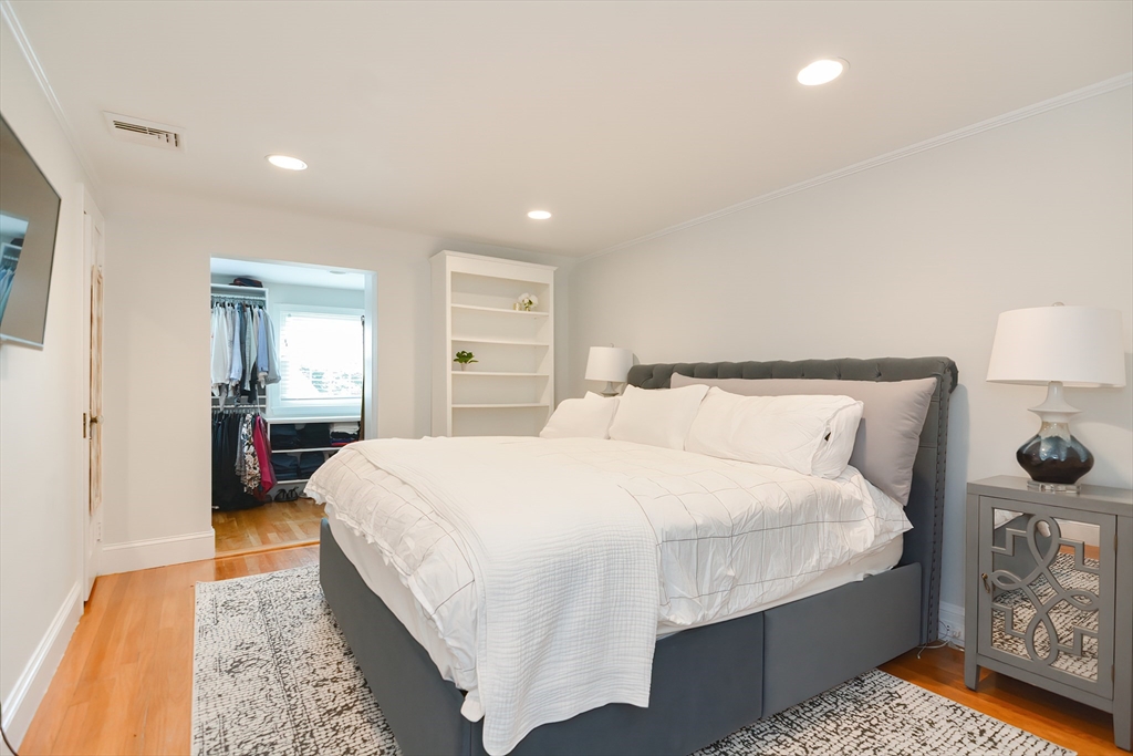 1133 Brook Road Milton, MA 02186 - Photo 38 of 40 a bedroom with a bed and wooden floor