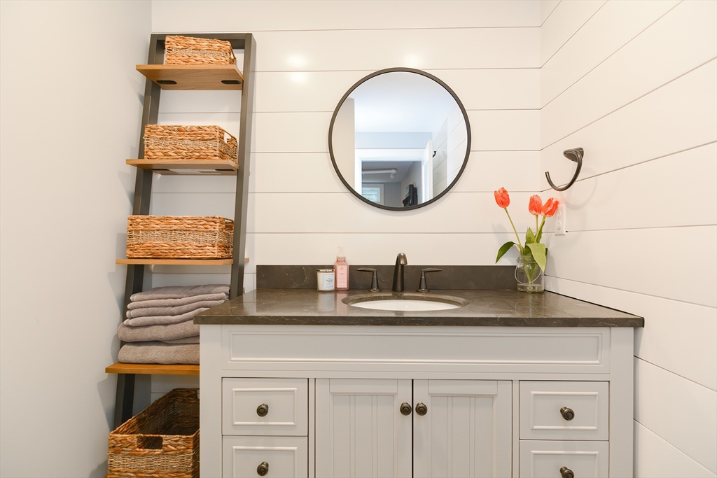 1133 Brook Road Milton, MA 02186 - Photo 39 of 40 a bathroom with a sink and a mirror