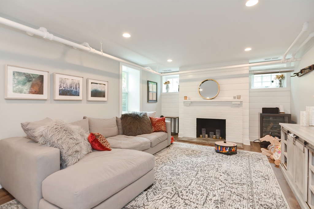 1133 Brook Road Milton, MA 02186 - Photo 40 of 40 a living room with furniture and a fireplace