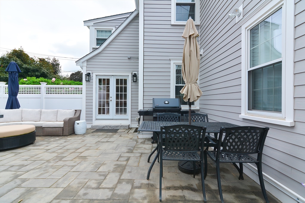 1133 Brook Road Milton, MA 02186 - Photo 9 of 40 a patio with table and chairs and potted plants