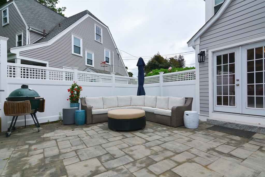 1133 Brook Road Milton, MA 02186 - Photo 10 of 40 a view of a patio with couches and a potted plant on a table